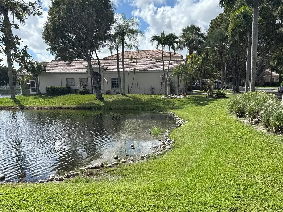 Finished bank with grass to the water behind the homes